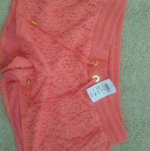 Coral shorts with gold accents